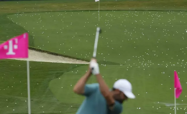 Scottie Scheffler warms up on the driving range before a practice round for the PGA Championship golf tournament at the Quail Hollow Club, Monday, May 12, 2025, in Charlotte, N.C. (AP Photo/Matt York)
