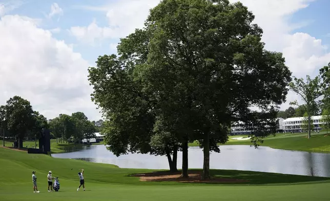 Si Woo Kim, of South Korea, hits from the fairway on the 15th hole during a practice round for the PGA Championship golf tournament at the Quail Hollow Club, Tuesday, May 13, 2025, in Charlotte, N.C. (AP Photo/David J. Phillip)