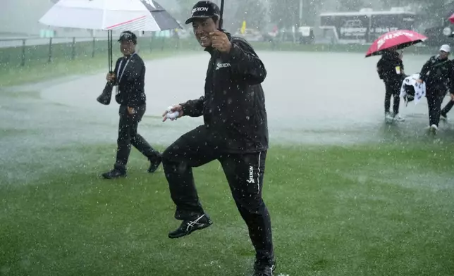 Hideki Matsuyama, of Japan, plays in the rain during a practice round for the PGA Championship golf tournament at the Quail Hollow Club, Monday, May 12, 2025, in Charlotte, N.C. (AP Photo/Matt York)