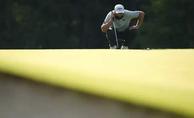 Jon Rahm, of Spain, lines up a putt on the 12th hole during the first round of the PGA Championship golf tournament at the Quail Hollow Club, Thursday, May 15, 2025, in Charlotte, N.C. (AP Photo/Matt York)