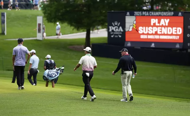 Xander Schauffele leaves the course after play was suspended during a practice round for the PGA Championship golf tournament at the Quail Hollow Club, Tuesday, May 13, 2025, in Charlotte, N.C. (AP Photo/David J. Phillip)