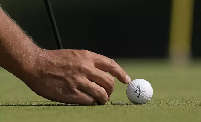 Xander Schauffele lines up a putt on the 17th hole during the first round of the PGA Championship golf tournament at the Quail Hollow Club, Thursday, May 15, 2025, in Charlotte, N.C. (AP Photo/David J. Phillip)