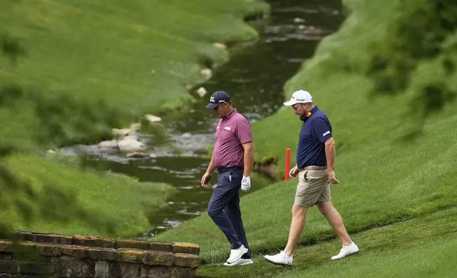 Padraig Harrington, of Ireland, and Shane Lowry walk on the 13th hole during a practice round for the PGA Championship golf tournament at the Quail Hollow Club, Wednesday, May 14, 2025, in Charlotte, N.C. (AP Photo/George Walker IV)