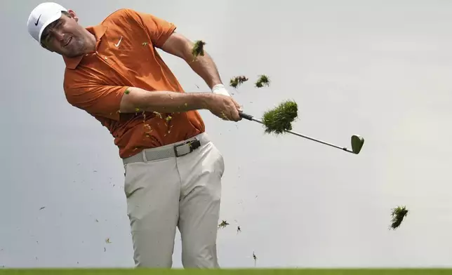 Scottie Scheffler hits from the rough on the 15th hole during a practice round for the PGA Championship golf tournament at the Quail Hollow Club, Wednesday, May 14, 2025, in Charlotte, N.C. (AP Photo/George Walker IV)