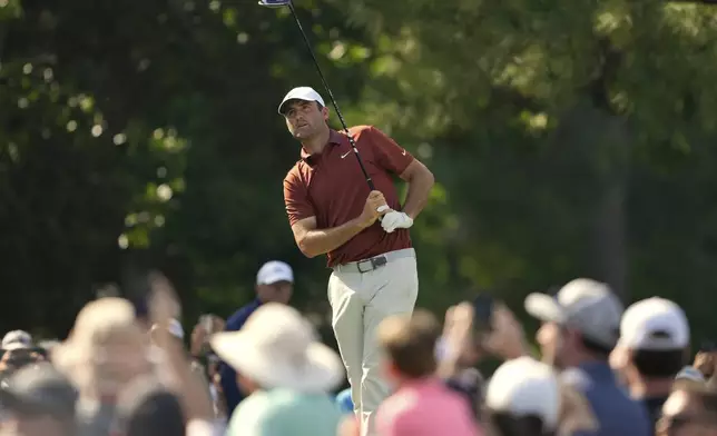 Scottie Scheffler watches his tee shot on the 15th hole during the first round of the PGA Championship golf tournament at the Quail Hollow Club, Thursday, May 15, 2025, in Charlotte, N.C. (AP Photo/Matt York)
