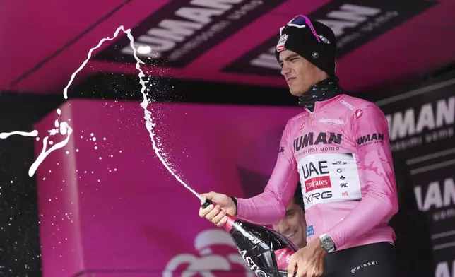 Mexico's Isaac Del Toro Romero of Uae Team Emirates Xrg celebrates on the podium with the pink jersey after the stage 11 of the Giro d'Italia cycling race, 186 km from Viareggio to Castelnovo ne' Monti, Italy, Wednesday, May 21, 2025. (Gian Mattia D'Alberto/LaPresse via AP)