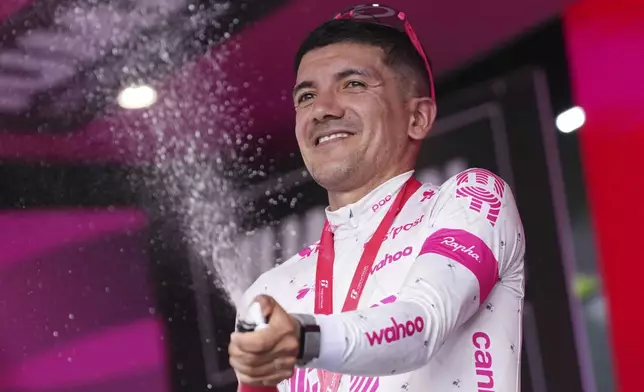 Ecuador's Richard Carapaz of Ef Education - Easypost Team celebrates on the podium after winning the stage 11 of the Giro d'Italia cycling race, 186 km from Viareggio to Castelnovo ne' Monti, Italy, Wednesday, May 21, 2025. (Gian Mattia D'Alberto/LaPresse via AP)