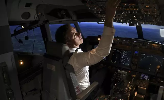 Capt. Miles Morgan, managing director of flight training for United Airlines, flies a simulator at the company's training campus in Denver, Friday, May 16, 2025. (AP Photo/Thomas Peipert)