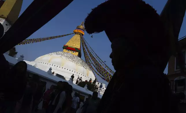 A Buddhist monk circumambulates the Boudhanath stupa during Buddha Jayanti, also known as Buddha Purnima festival, to celebrate Buddha's birthday, in Kathmandu, Nepal, Monday, May 12, 2025. (AP Photo/Niranjan Shrestha)