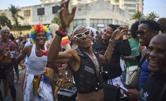 A member of the LGBTQ+ community dances during a Gay Pride march in support of the fight for tolerance and acceptance, in Havana, Cuba, Saturday, May 10, 2025. (AP Photo/Ramon Espinosa)