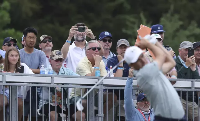 Fans watch from the gallery as Jordan Spieth, front, hits off the seventh tee during the first round of the CJ Cup Byron Nelson golf tournament in McKinney, Texas, Thursday, May 1, 2025. (AP Photo/Gareth Patterson)