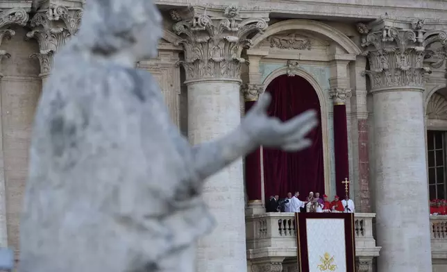 A statue of the Bernini Colonnade frames Pope Leo XIV appearing on the balcony of St Peter's Basilica after his election, at the Vatican, Thursday, May 8, 2025. (AP Photo/Luca Bruno)