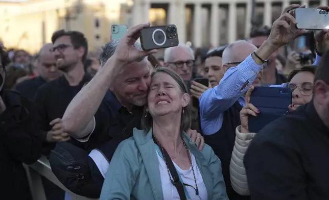People react as the newly elected Pope Leo XIV appears on the balcony of St. Peter's Basilica at the Vatican, Thursday, May 8, 2025. (AP Photo/Emilio Morenatti)