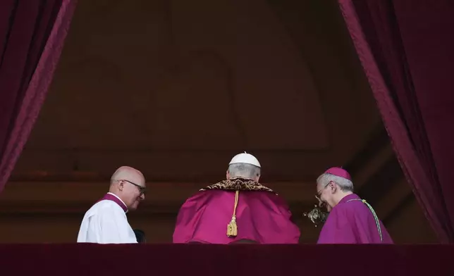 Newly elected Pope Leo XIV leaves the balcony of St. Peter's Basilica after addressing faithful at the Vatican, Thursday, May 8, 2025. (AP Photo/Alessandra Tarantino)