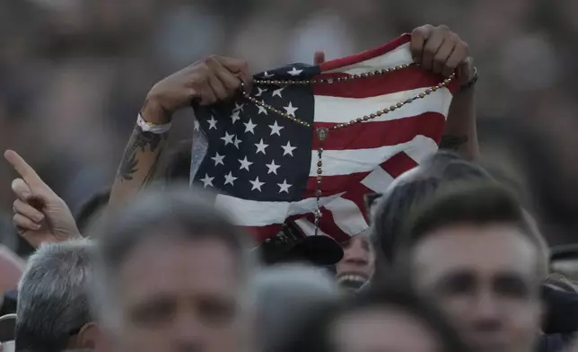 An American flag is waved following the election of Pope Leo XIV, at the Vatican, Thursday, May 8, 2025. (AP Photo/Andrew Medichini)
