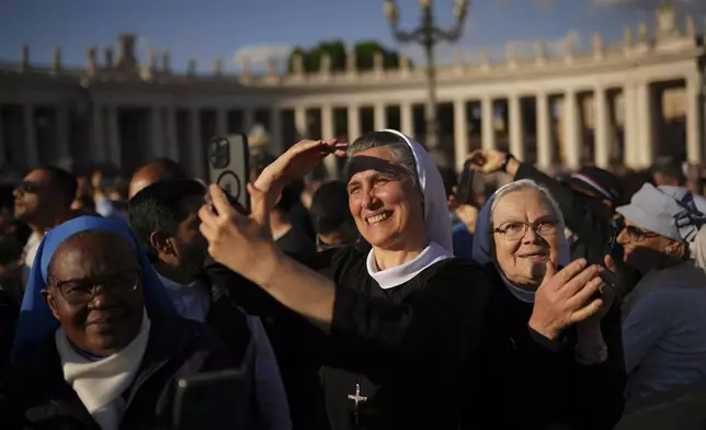 Nuns react after the announcement of the newly elected Pope Leo XIV at the Vatican, Thursday, May 8, 2025. (AP Photo/Francisco Seco)