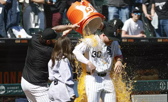 Chicago White Sox's Tim Elko, front right, is doused by teammates after a baseball game against the Miami Marlins, Sunday, May 11, 2025, in Chicago. (AP Photo/Kamil Krzaczynski)