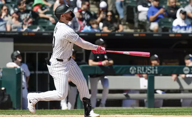 Chicago White Sox's Tim Elko hits a three-run home run against the Miami Marlins during the sixth inning of a baseball game Sunday, May 11, 2025, in Chicago. (AP Photo/Kamil Krzaczynski)