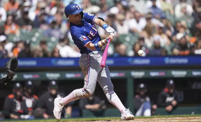 Texas Rangers' Josh Jung hits a two-run home run against the Detroit Tigers in the fifth inning during a baseball game, Sunday, May 11, 2025, in Detroit. (AP Photo/Paul Sancya)