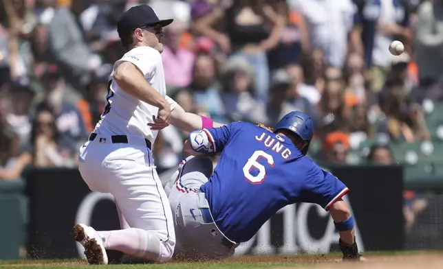 Texas Rangers' Josh Jung (6) slides safely into third base as Detroit Tigers third baseman Jace Jung, left, can't handle the throw in the second inning during a baseball game, Sunday, May 11, 2025, in Detroit. (AP Photo/Paul Sancya)