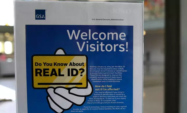 FILE - In this photo taken April 6, 2016, a sign at the federal courthouse in Tacoma, Wash., is shown to inform visitors of the federal government's REAL ID act. (AP Photo/Ted S. Warren, file)