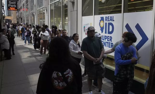 People line up to apply for Real ID at a Real ID Supercenter in downtown Chicago, Tuesday, May 6, 2025. (AP Photo/Kiichiro Sato)