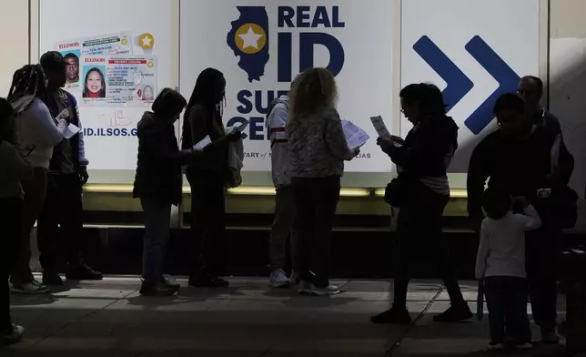 People line up to apply for Real ID at a Real ID Supercenter in downtown Chicago, Tuesday, May 6, 2025. (AP Photo/Kiichiro Sato)
