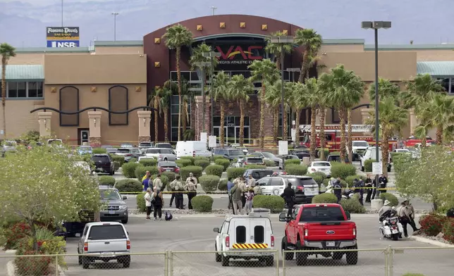 Las Vegas Metro Police officers are shown in front of a Las Vegas Athletic Club after a shooting Friday, May 16, 2025, in Las Vegas. (Steve Marcus/Las Vegas Sun via AP)