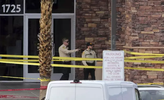 Las Vegas Metro Police officers are shown by the main entrance of a Las Vegas Athletic Club after a shooting Friday, May 16, 2025. 2025, in Las Vegas. (Steve Marcus/Las Vegas Sun via AP)
