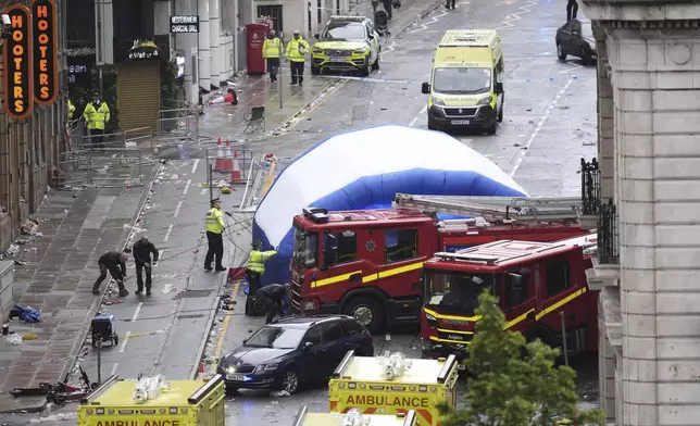 A tent is erected by police at the site of an incident on Water Street near the Liver Building in Liverpool after a car collided with pedestrians during the Premier League winners parade, in Liverpool, England, Monday May 26, 2025. (Danny Lawson/PA via AP)