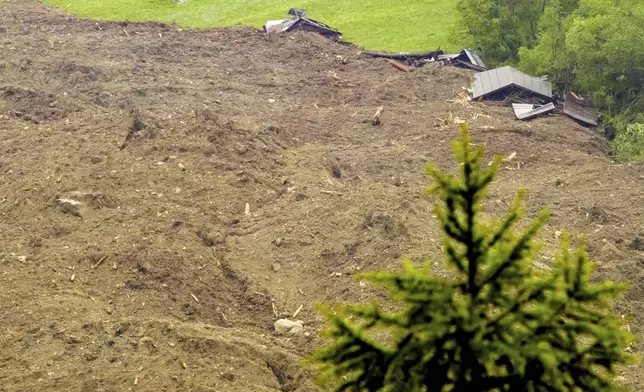A large avalanche with a mixture of ice, rock, snow and water reach the valley floor is pictured in Wiler after the Birch glacier collapsing above Blatten, Switzerland, Wednesday, May 28, 2025. (Jean-Christophe Bott/Keystone via AP)