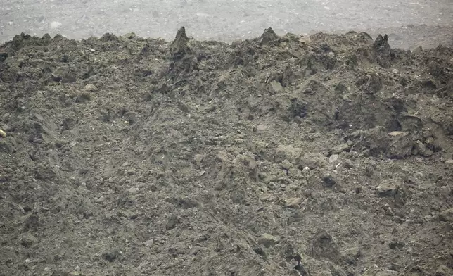 A large avalanche with a mixture of ice, rock, snow and water reach the valley floor is pictured in Wiler after the Birch glacier collapsing above Blatten, Switzerland, Wednesday, May 28, 2025. (Jean-Christophe Bott/Keystone via AP)