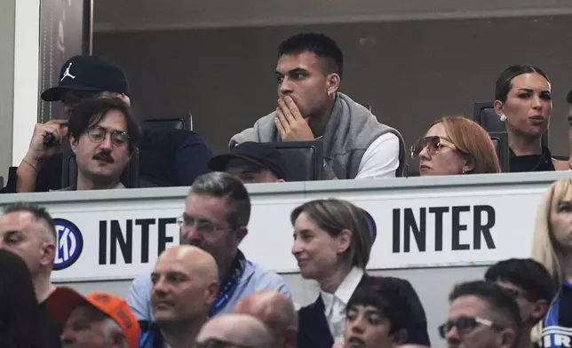 Inter Milan's Lautaro Martinez, center top, watches from the tribune during the Serie A soccer match between Inter Milan and Hellas Verona at the San Siro Stadium, in Milan, Italy, Saturday, May 3, 2025. (AP Photo/Antonio Calanni)