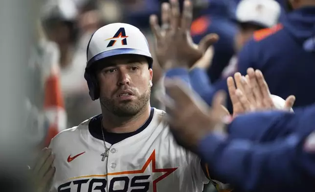 Houston Astros designated hitter Victor Caratini celebrates after scoring off of a single hit by Jake Meyers during the eighth inning of a baseball game against the Kansas City Royals in Houston, Monday, May 12, 2025. (AP Photo/Ashley Landis)