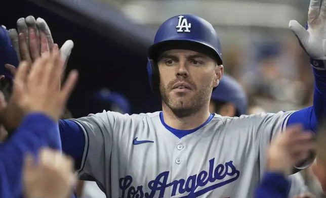 Los Angeles Dodgers' Freddie Freeman (5) celebrates his two-run home run during the third inning of a baseball game against the Miami Marlins, Monday, May 5, 2025, in Miami. (AP Photo/Marta Lavandier)