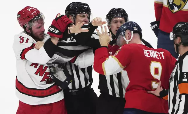 Carolina Hurricanes right wing Andrei Svechnikov (37) and Florida Panthers center Sam Bennett (9) are separated during the third period in Game 3 of the NHL hockey Stanley Cup Eastern Conference finals Saturday, May 24, 2025, in Sunrise, Fla. (AP Photo/Lynne Sladky)