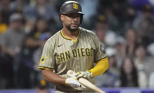 San Diego Padres' Elias Díaz reacts after striking out against Colorado Rockies catcher Jacob Stallings, who was called into duty as a relief pitcher, in the ninth inning of a baseball game Saturday, May 10, 2025, in Denver. (AP Photo/David Zalubowski)