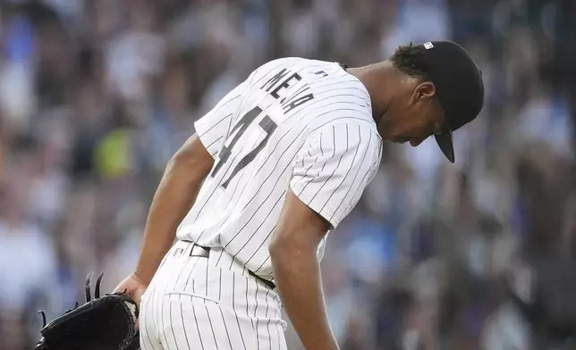 Colorado Rockies relief pitcher Juan Mejia reacts after giving up a three-run home run to San Diego Padres' Fernando Tatis Jr. in the fifth inning of a baseball game Saturday, May 10, 2025, in Denver. (AP Photo/David Zalubowski)