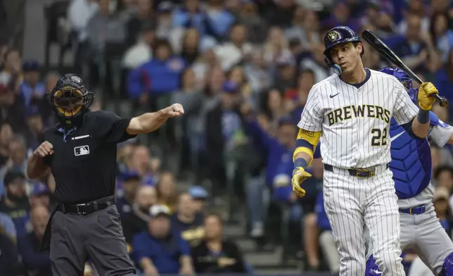 Milwaukee Brewers' Christian Yelich (22) is called out on strikes during the first inning of a baseball game against the Chicago Cubs, Saturday, May 3, 2025, in Milwaukee. (AP Photo/Jeffrey Phelps)