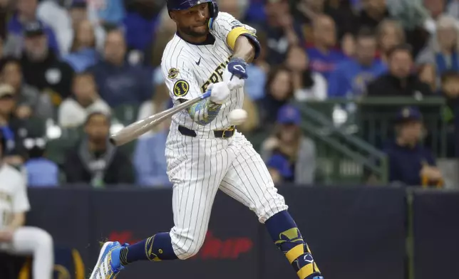 Milwaukee Brewers' Jackson Chourio hits a double against the Chicago Cubs during the third inning of a baseball game, Saturday, May 3, 2025, in Milwaukee. (AP Photo/Jeffrey Phelps)