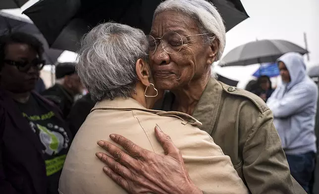 Amina Baraka, mother of Newark Mayor Ras J. Baraka, hugs Rep. Bonnie Watson Coleman, D-N.J., outside of an ICE office after her son's arrest, Friday, May 9, 2025, in Newark, N.J. (AP Photo/Angelina Katsanis)