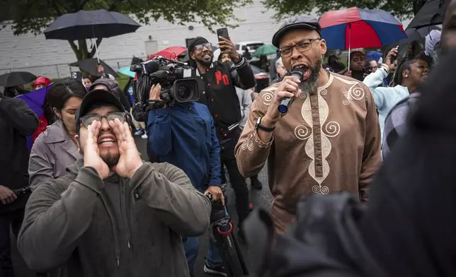 Protestors shout "Let him out" to demand the release of Newark Mayor Ras Baraka after his arrest while protesting outside an ICE detention prison, Friday, May 9, 2025, in Newark, N.J, (AP Photo/Angelina Katsanis)