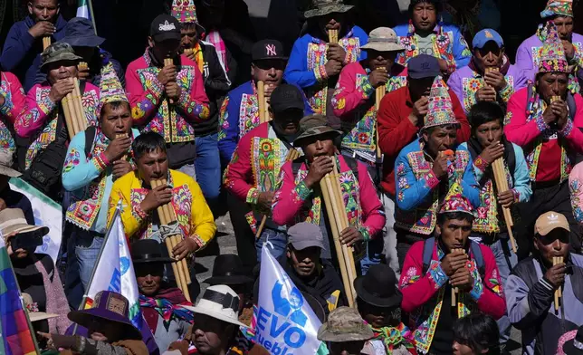 Quechua musicians play flutes in support of former President Evo Morales during a march to the Electoral Tribunal offices in El Alto, Bolivia, Friday, May 16, 2025. (AP Photo/Juan Karita)