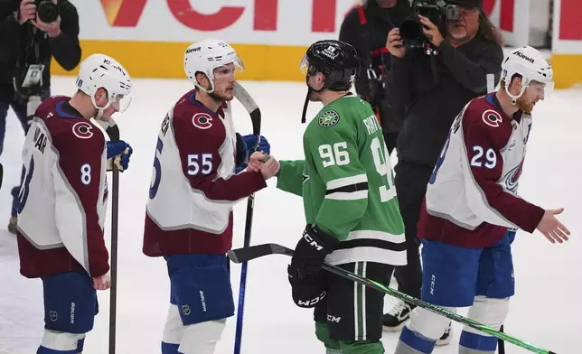 Colorado Avalanche's Cale Makar (8), Ryan Lindgren (55) Dallas Stars' Mikko Rantanen (96) and Nathan MacKinnon (29) exchange handshakes after the Stars 4-2 win in Game 7 of a first-round NHL hockey playoff series Saturday, May 3, 2025, in Dallas. (AP Photo/Julio Cortez)