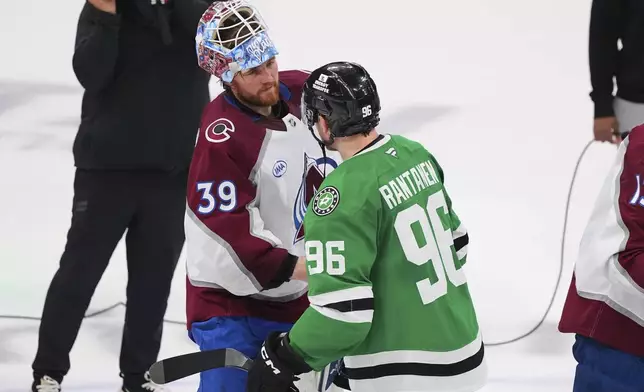 Colorado Avalanche's Mackenzie Blackwood (39) and Dallas Stars' Mikko Rantanen (96) shake hands after the Stars 4-2 win in Game 7 of a first-round NHL hockey playoff series Saturday, May 3, 2025, in Dallas. (AP Photo/Julio Cortez)