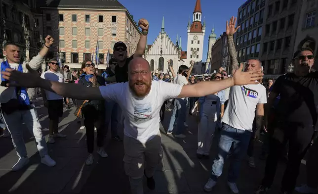 Soccer fans cheer ahead of the Champions League final soccer match between Paris Saint-Germain and Inter Milan in Munich, Germany, Friday, May 30, 2025. (AP Photo/Markus Schreiber)
