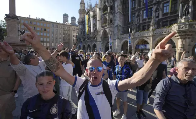 Soccer fans cheer ahead of the Champions League final soccer match between Paris Saint-Germain and Inter Milan in Munich, Germany, Friday, May 30, 2025. (AP Photo/Markus Schreiber)
