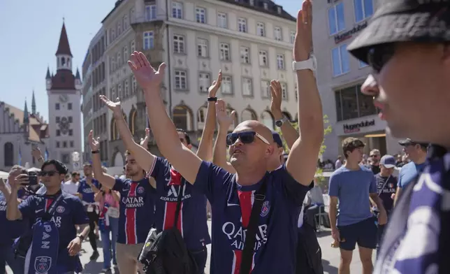 Paris Saint-Germain fans cheers at the Marienplatz in the city center ahead of the Champions League final soccer match between Paris Saint-Germain and Inter Milan in Munich, Germany, Saturday, May 31, 2025. (AP Photo/Markus Schreiber)