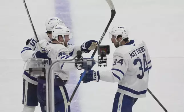 Toronto Maple Leafs defenseman Morgan Rielly (44) celebrates a goal during the third period in Game 3 of a second-round NHL hockey playoff series against the Florida Panthers, Friday, May 9, 2025, in Sunrise, Fla. (AP Photo/Marta Lavandier)