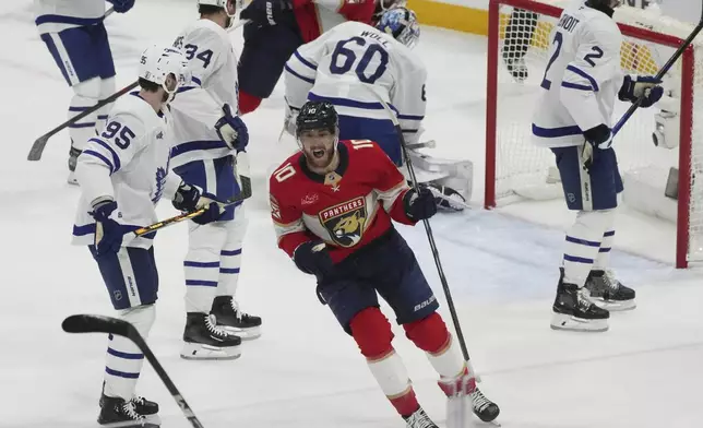 Florida Panthers left wing A.J. Greer (10) celebrates a goal by teammate Tomas Nosek during the second period in Game 3 of a second-round NHL hockey playoff series against the Toronto Maple Leafs, Friday, May 9, 2025, in Sunrise, Fla. (AP Photo/Marta Lavandier)